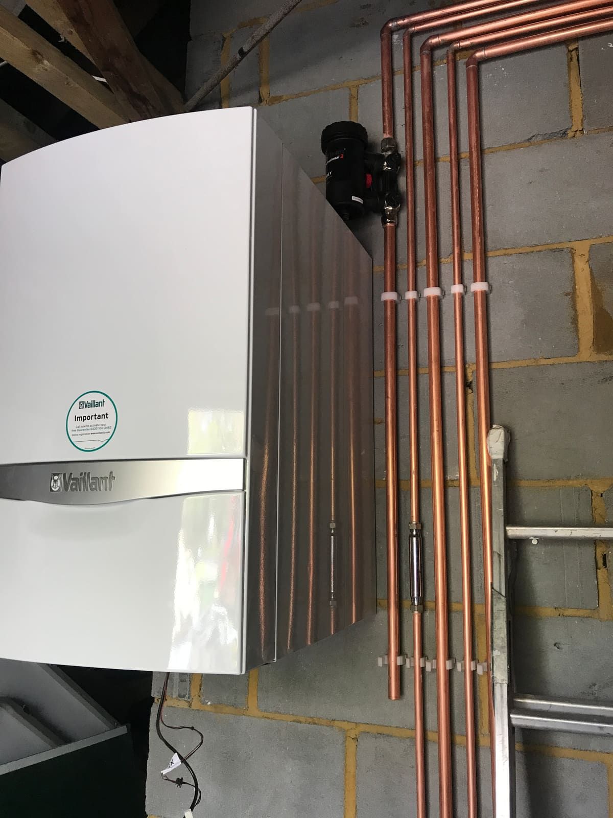 Vaillant boiler installed on a wall with copper pipework