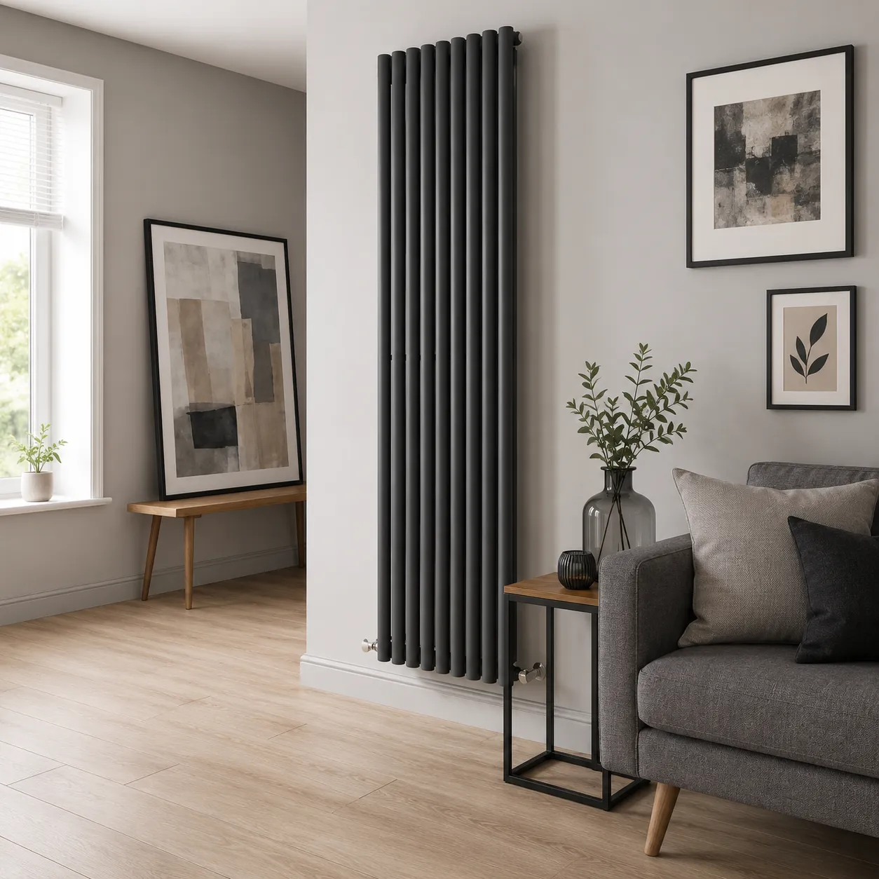 A full height vertical column radiator in anthracite grey, made of rounded vertical tubes.